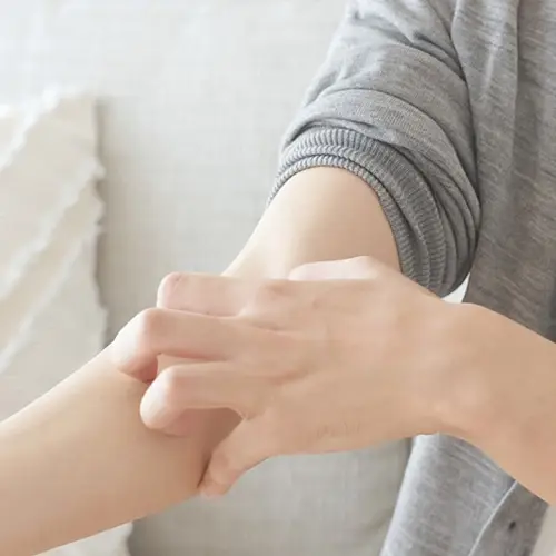 Person scrating their inner arm